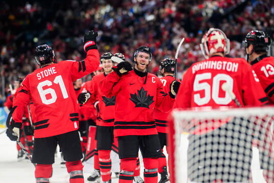 Mark Stone and Connor McDavid of Canada celebrates