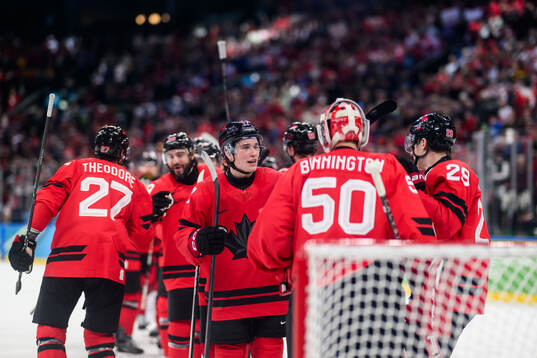 Macklin Celebrini and goaltender Jordan Binnington of