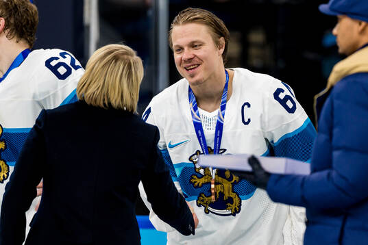 Mikael Granlund of Finland with their bronze medals at the