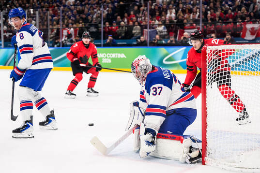 Zach Werenski and goaltender Connor Hellebuyck of USA