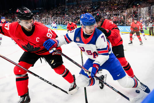 Brady Tkachuk of USA against Connor McDavid and Devon Toews
