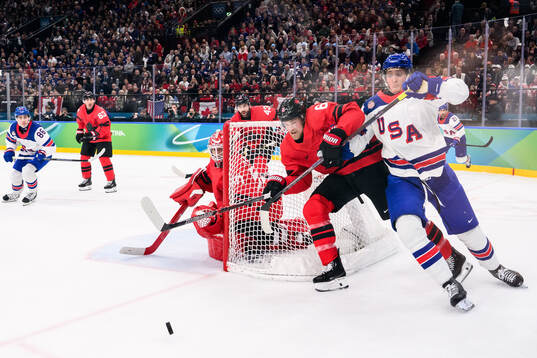 Tage Thompson of USA against Travis Sanheim of Canada in