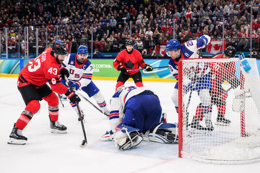 Tom Wilson of Canada against Charlie McAvoy and goaltender