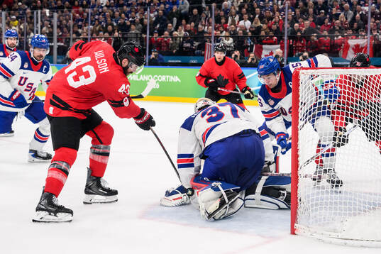 Tom Wilson of Canada against Charlie McAvoy and goaltender