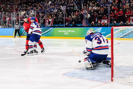 Nathan MacKinnon of Canada against Quinn Hughes and