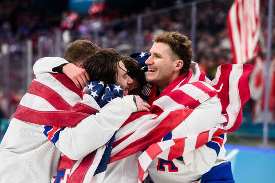 Matthew Tkachuk and Quinn Hughes of USA celebrate