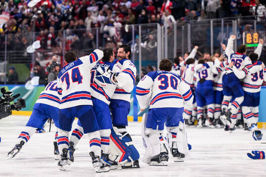 Goaltender Connor Hellebuyck and Jaccob Slavin of USA