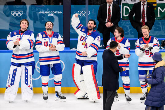 Auston Matthews and goaltender Connor Hellebuyck of USA
