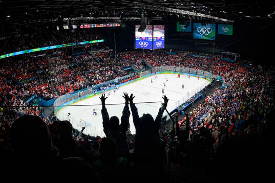 Spectators celebrate as Jack Hughes of USA scores the