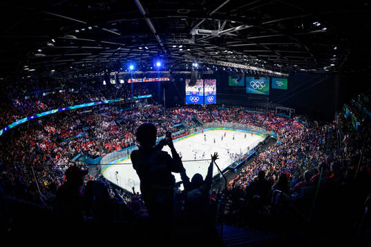 Spectators celebrate as Jack Hughes of USA scores the