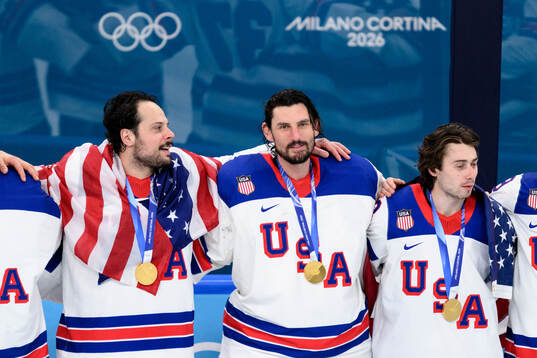 Auston Matthews and Connor Hellebuyck of USA with their