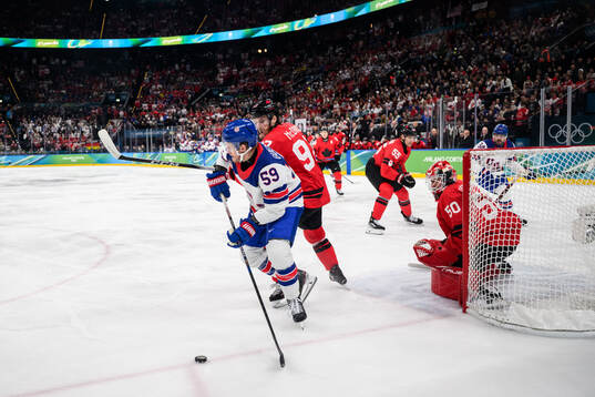 Jake Guentzel of USA against Connor McDavid and goaltender
