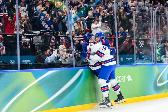 Matt Boldy and Brock Faber of USA celebrate