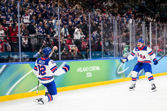 Matt Boldy and Brock Faber of USA celebrate