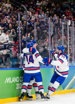 Matt Boldy, Brock Faber and Jaccob Slavin of USA celebrate