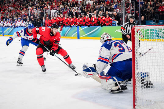 Connor McDavid of Canada against Brock Faber and goaltender