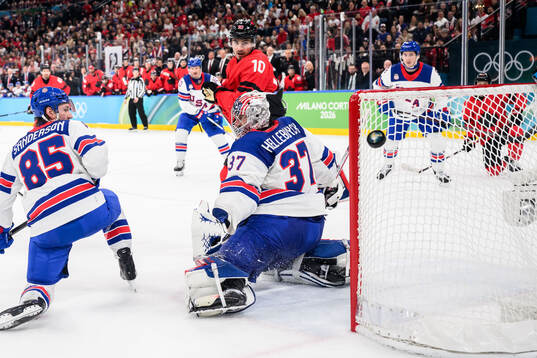 Nick Suzuki of Canada against Jake Sanderson and goaltender
