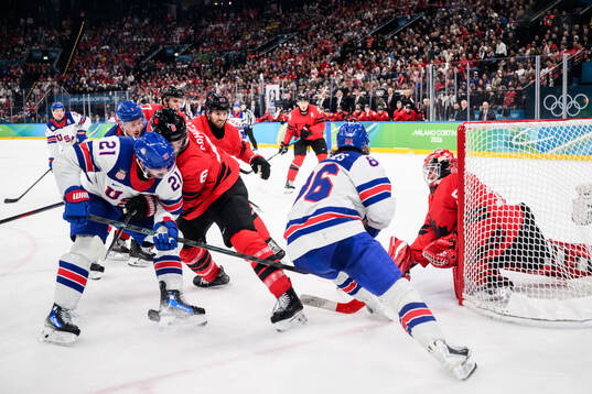 Dylan Larkin and Jack Hughes of USA against Travis Sanheim