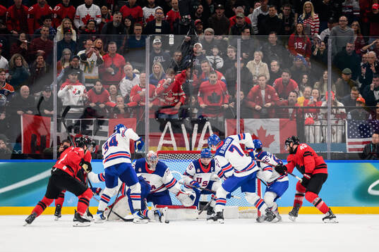Tom Wilson of Canada against goaltender Connor Hellebuyck