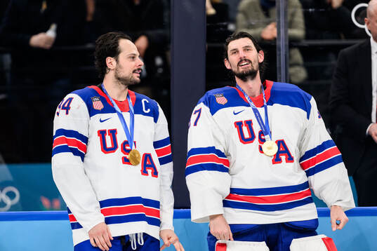 Auston Matthews and goaltender Connor Hellebuyck of USA