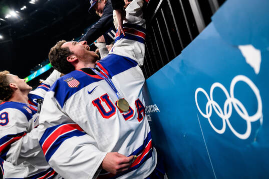 Jeremy Swayman of USA celebrate