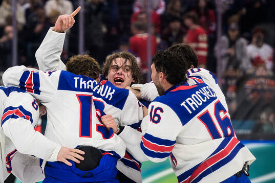 Jack Hughes of USA celebrates with teammates Zach Werenski,