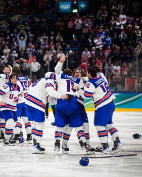 Jack Hughes of USA celebrates with teammates Zach Werenski,