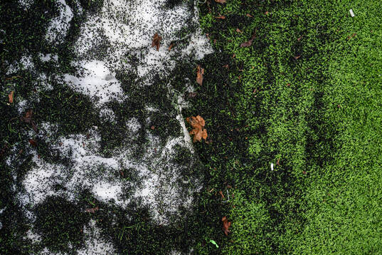 Snö med gummigranulat på konstgräs