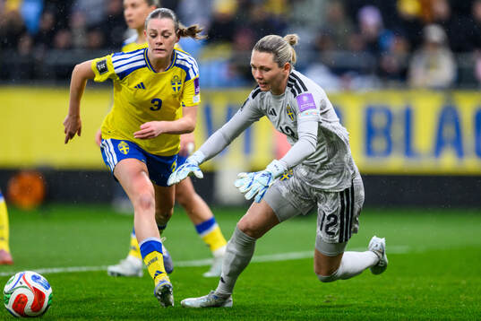 Sofia Reidy and goalkeeper Jennifer Falk of Sweden