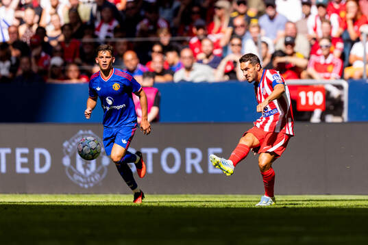 Shea Lacey of Manchester United and Koke of Atletico de
