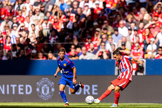 Shea Lacey of Manchester United and Koke of Atletico de