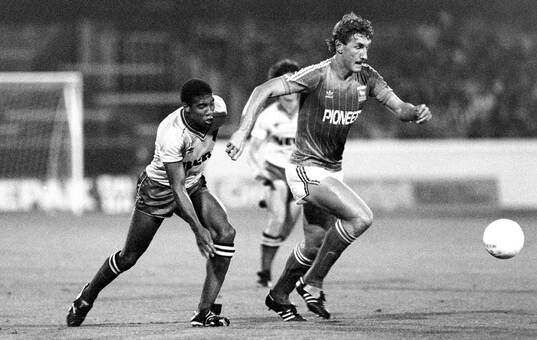  John Barnes of Watford and Terry Butcher of Ipswich.   